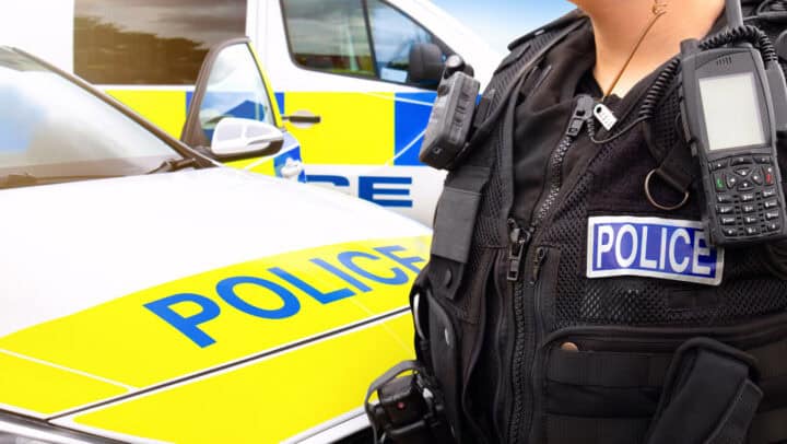Police officer and police car - scene of emergency services' cop