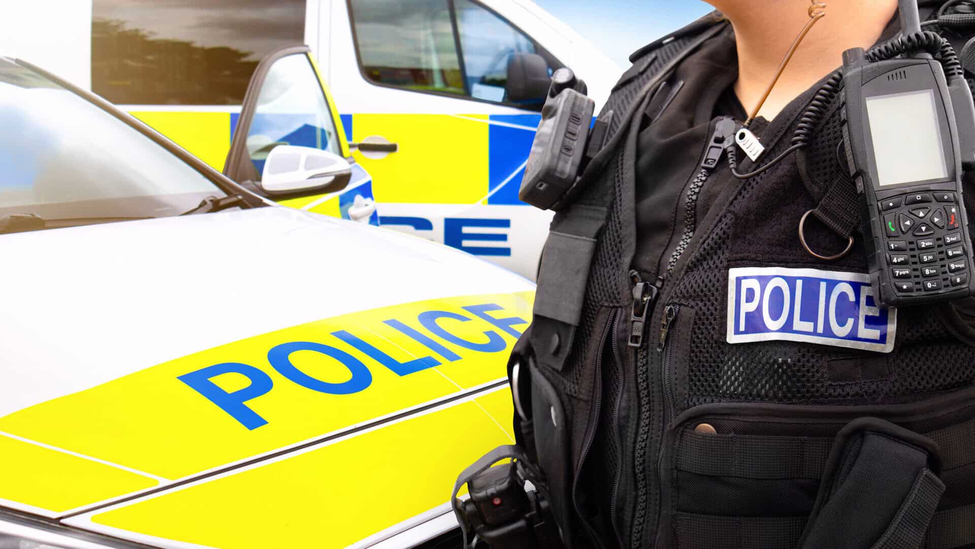 Police officer and police car - scene of emergency services' cop
